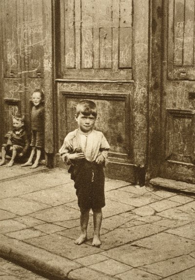 Barefoot child on a London street by English Photographer